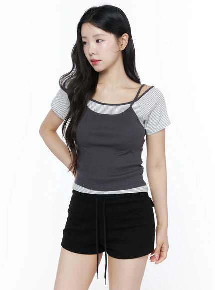 Layered Cami Striped Tee IU525 Dark gray model angled front shot looking left hand on hip layered cami over striped short sleeve tee with black shorts