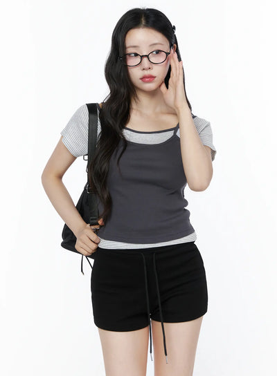 LEWKIN Layered Cami Striped Tee IU525 Dark gray model front shot three-quarter view with backpack and glasses layered cami over stripe tee ribbed fabric S/M
