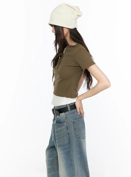 Layered Henley Short Sleeve Tee CL523 Dark green side profile close-up on model showing ribbed seam detail, fitted crop silhouette and layered white undershirt hem