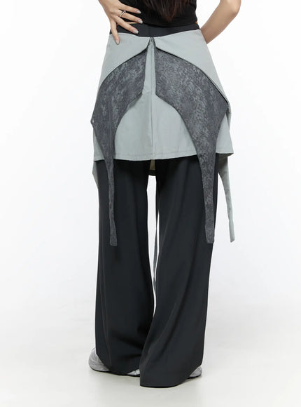Layered Lace Mini Skirt CL524 Gray back close-up on model revealing lace panel cutout, center zip and draped skirt overlay above black pants