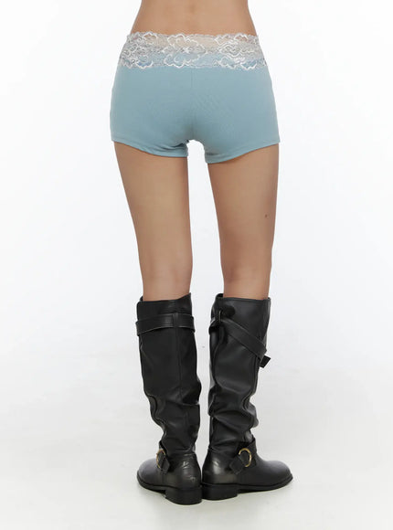 Layered Lace Shorts CL510 blue back shot on model showing white lace waistband trim smooth fabric and minimal seam detail styled with boots