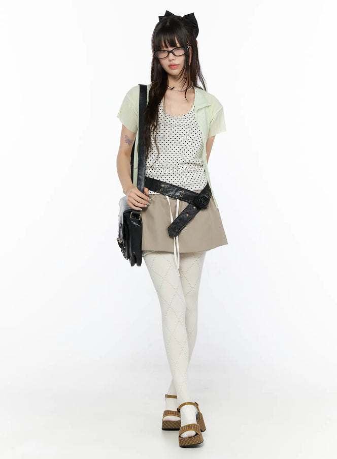 Layered Low-Rise Mini Skirt CL523 Beige full-body front model shot styled with polka dot tank green cardigan black belt bag and white tights