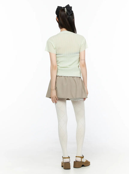 Layered Low-Rise Mini Skirt CL523 Beige full-body back model shot showing back hemline flare ruffle lining and mint top paired with white tights