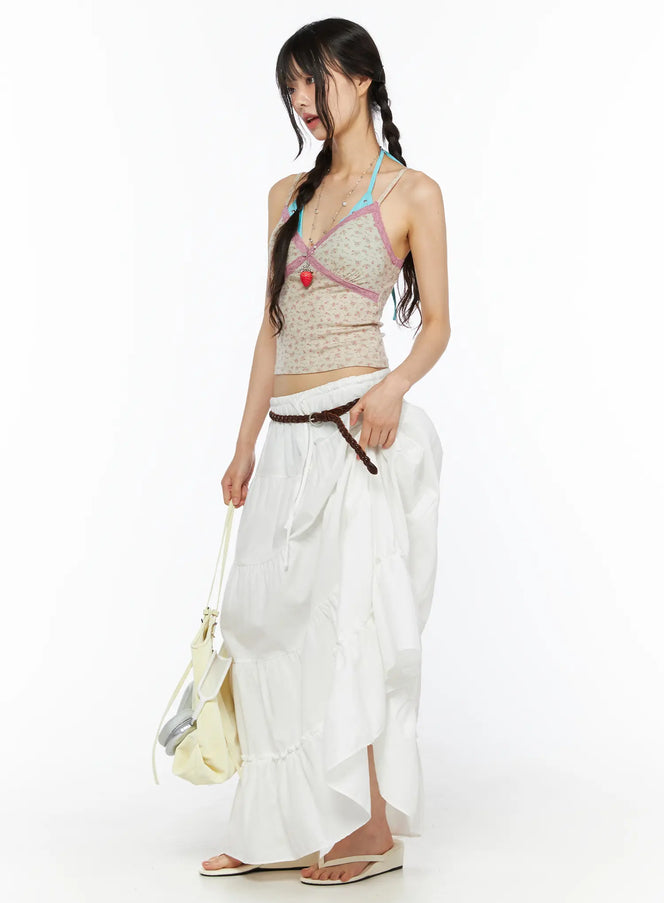 LEWKIN Layered Maxi Skirt CU530 white side shot on model with braided pigtails wearing floral cami top and brown braided belt holding bag