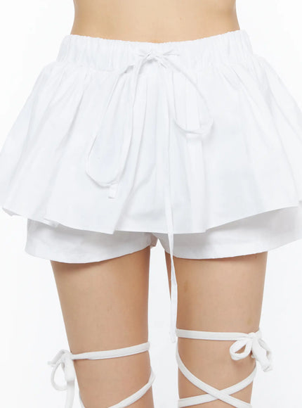 Layered Mini Skort CU530 white close-up detail shot on model showing elastic waistband bow tie pleated ruffle layer and inner shorts