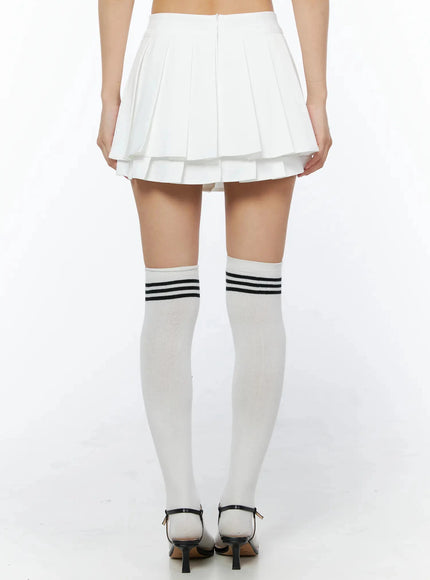 Layered Pleated Skirt IL509 White back close-up on model showing rear pleated panel, back zipper closure, and double-tiered hem detail