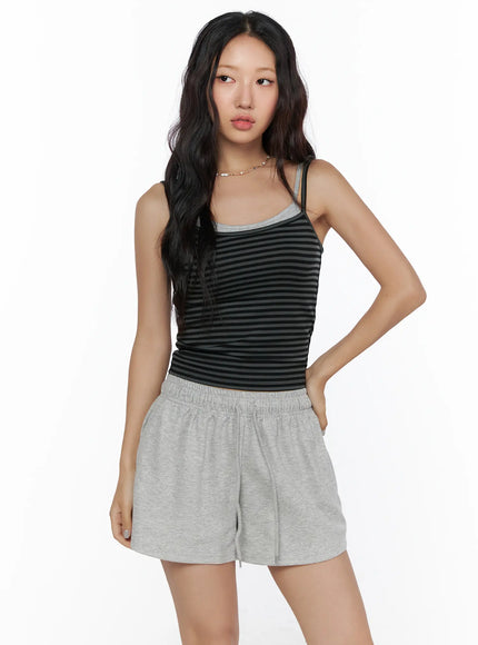 Layered Striped Cami Top CL513 Black three-quarter front view on model with gray shorts hand on hip looking off to the side