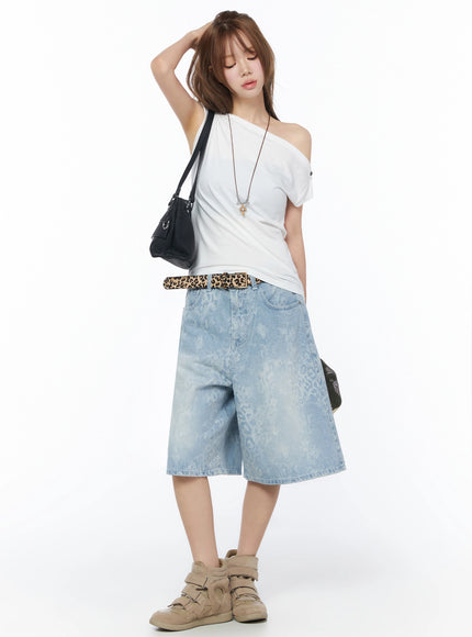 Leopard Print Jorts IU525 Light blue full-body styled shot on model with one hand raised wearing white off-shoulder top leopard belt and black shoulder bag