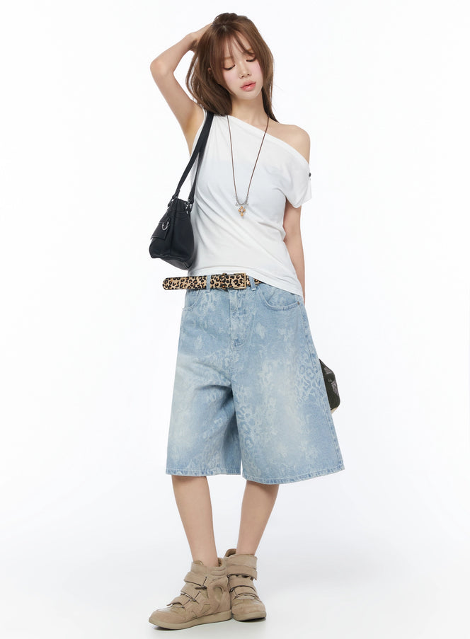 Leopard Print Jorts IU525 Light blue full-body styled shot on model with one hand raised wearing white off-shoulder top leopard belt and black shoulder bag
