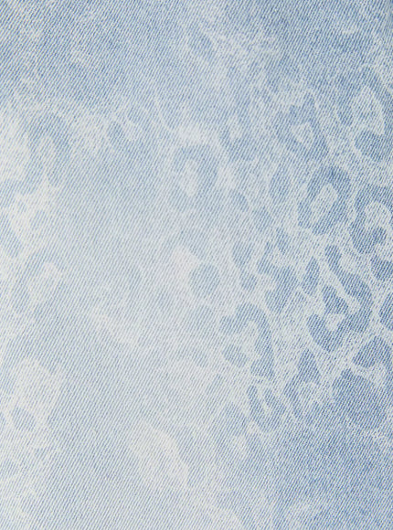 Leopard Print Jorts IU525 Light blue extreme close-up of fabric surface showing tonal leopard print pattern and acid-washed light blue denim texture detail