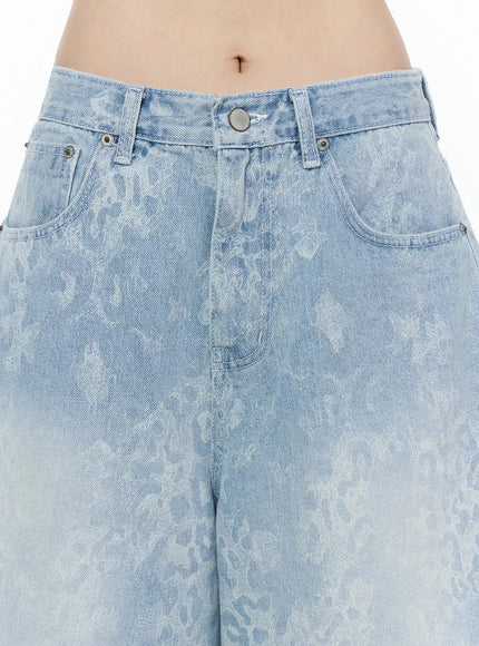 Leopard Print Jorts IU525 Light blue close-up detail of waistband silver button belt loops and tonal leopard jacquard pattern on light blue washed denim