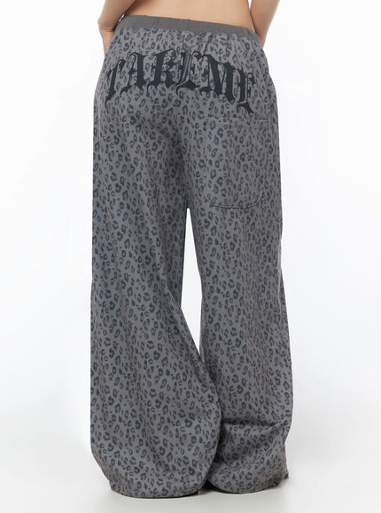 Leopard Print Wide-Leg Sweatpants IU525 Dark gray back crop shot on model showing close view of gothic TAKEME waistband print and back patch pocket