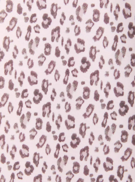 Leopard Print Wide-Leg Sweatpants IU525 Pink close-up fabric texture shot showing soft cotton leopard print with mauve spots on pale pink base