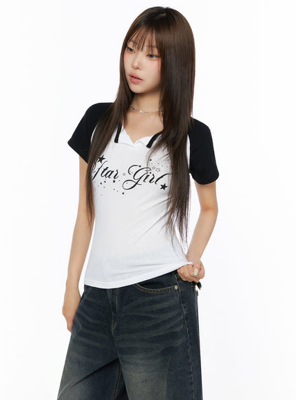 Lettering Raglan Slit Short Sleeve Tee IL515 White front shot on model with black raglan sleeves Star Girl script print paired with dark wide-leg jeans