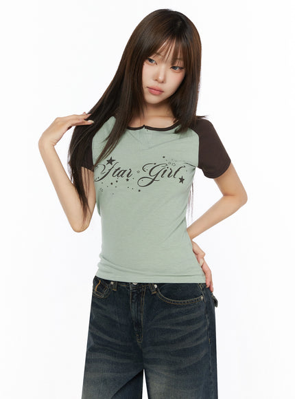 Lettering Raglan Slit Short Sleeve Tee IL515 Mint front shot on model one hand touching hair showing slim ribbed knit body and brown raglan sleeves with jeans