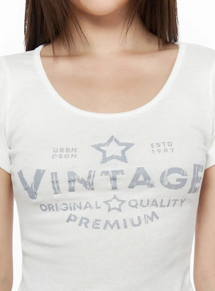 Lettering U-Neck Slim Short Sleeve Tee IL515 White close-up detail shot showing distressed VINTAGE star graphic print and U-neckline on model