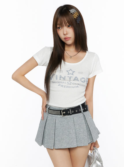 LEWKIN Lettering U-Neck Slim Short Sleeve Tee IL515 White S/M front shot on model styled with grey pleated mini skirt and star hair clips
