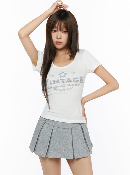 Lettering U-Neck Slim Short Sleeve Tee IL515 White front shot on model with one hand raised to hair showing slim ribbed body and graphic print
