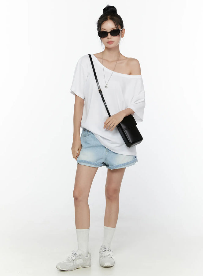 Light Washed Denim Shorts CL520 Light blue full-body front shot on model styled with off-shoulder white tee black crossbody bag and sneakers