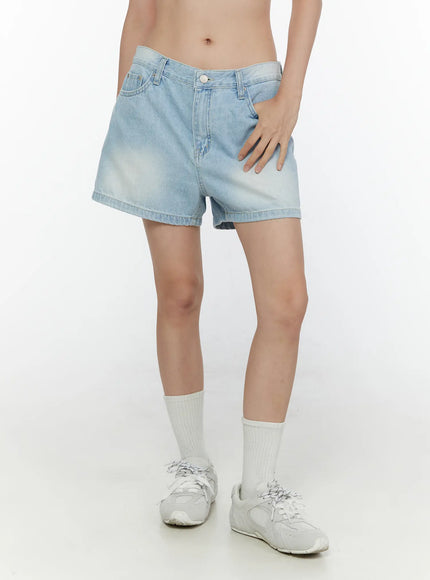 LEWKIN Light Washed Denim Shorts CL520 Light blue side shot on model hand on hip paired with white socks and sneakers faded denim texture