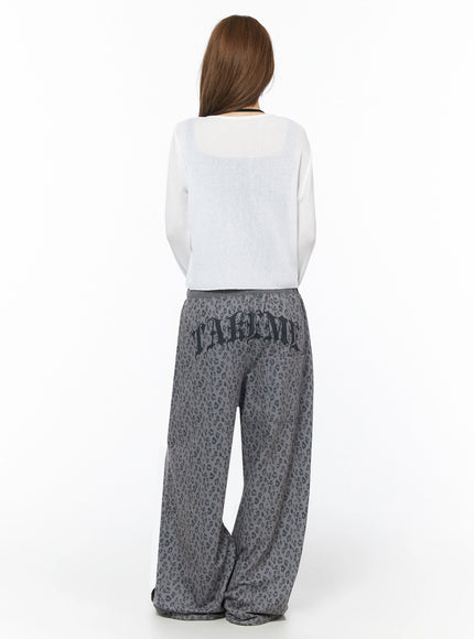 Lightweight Knit Cardigan IU525 White back shot on model, sheer ribbed knit showing semi-transparent texture and back silhouette with leopard pants