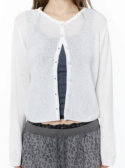 Lightweight Knit Cardigan IU525 White close-up front detail on model, showing sheer rib knit texture, button placket, and open front layered over gray tank