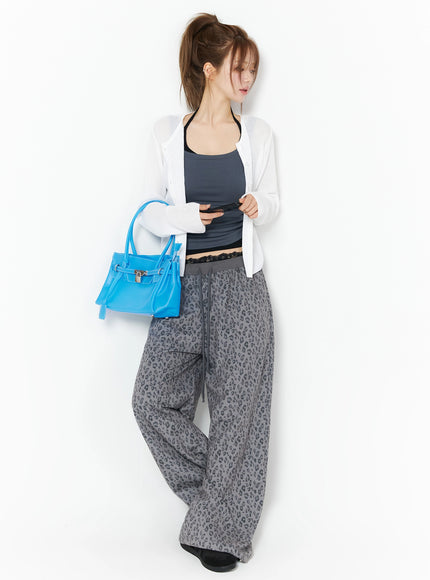 Lightweight Knit Cardigan IU525 White full-body front shot on model with high ponytail holding blue bag and phone, sheer ribbed knit open cardigan styled with leopard pants