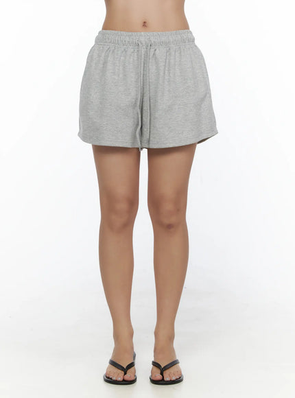 Lightweight Sweat Shorts CL513 Gray front shot on model from waist down showing full length elastic drawstring waist and curved hem with flip flops