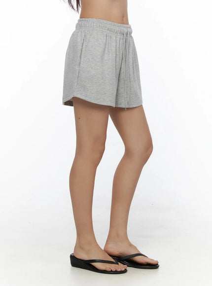 Lightweight Sweat Shorts CL513 Gray side shot on model showing drawstring waist curved hem silhouette styled with flip flops