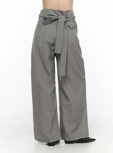 Linen Wrap Slacks CL527 Beige front full-body view on model styled with wide leather belt glasses and layered necklaces over white lace top and black flats