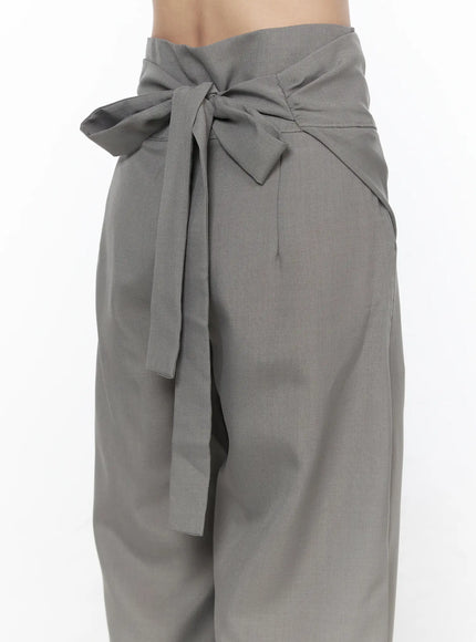 Linen Wrap Slacks CL527 Beige front three-quarter view on model showing wrap overlay high waistband and wide-leg silhouette with black patent flats