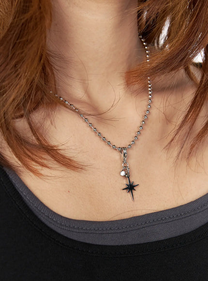 Logan Dog Tag Necklace IL522 silver worn on model neck close-up, north star pendant with small crystal charm on ball chain over black top
