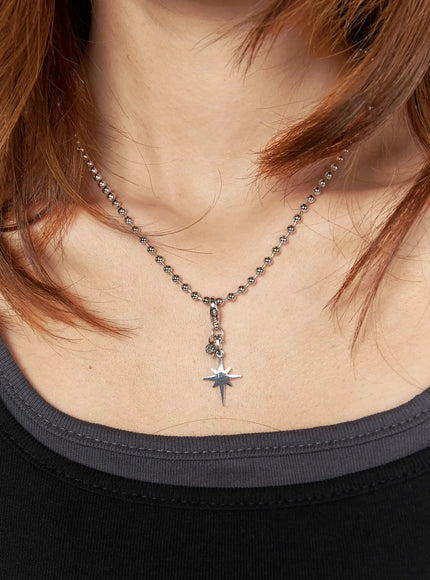Logan Dog Tag Necklace IL522 silver on model neck front view, north star charm pendant hanging from silver ball chain, styled with black layered top