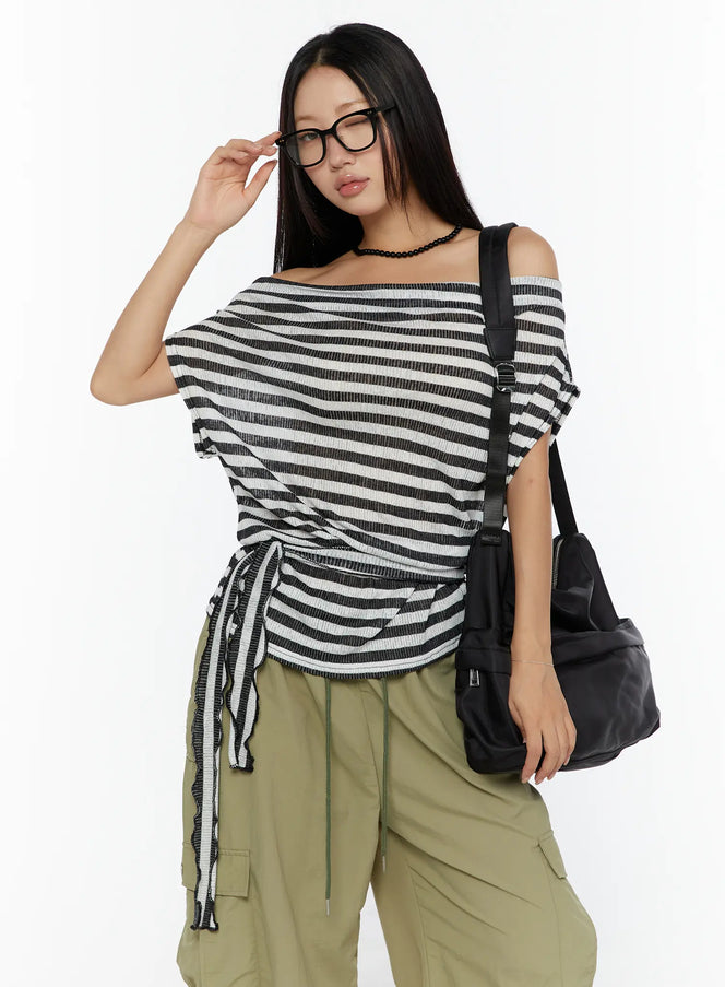 LEWKIN Loose Off-Shoulder Top CU526 Black front shot on model wearing glasses and crossbody bag, side-tie drawstring detail, ribbed stripe knit
