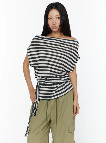 Loose Off-Shoulder Top CU526 Black front shot on model, off-shoulder neckline, hand on hip pose, ribbed stripe knit with side-tie drawstring