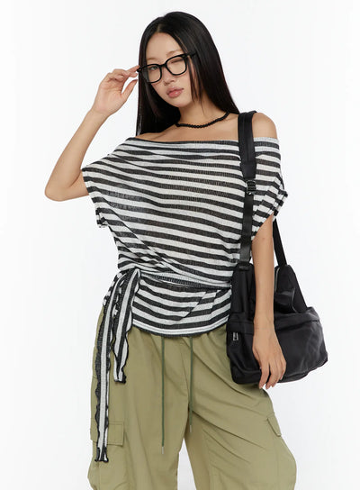 LEWKIN Loose Off-Shoulder Top CU526 Black front shot on model wearing glasses and crossbody bag, side-tie drawstring detail, ribbed stripe knit