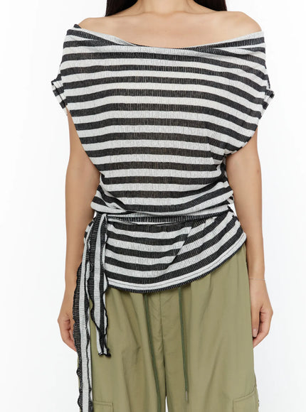 Loose Off-Shoulder Top CU526 Black close-up front torso shot on model, off-shoulder neckline and side drawstring tie detail, ribbed stripe texture