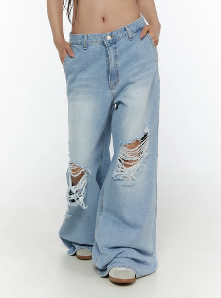 Lou Distressed Wide Leg Jeans CL508 Light blue side view on model hands in front pockets showcasing low rise waist and distressed knees