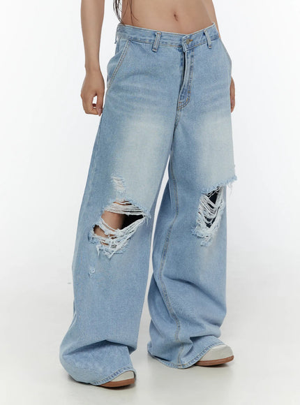 Lou Distressed Wide Leg Jeans CL508 Light blue side view on model hands in pockets showing wide leg silhouette and knee rips