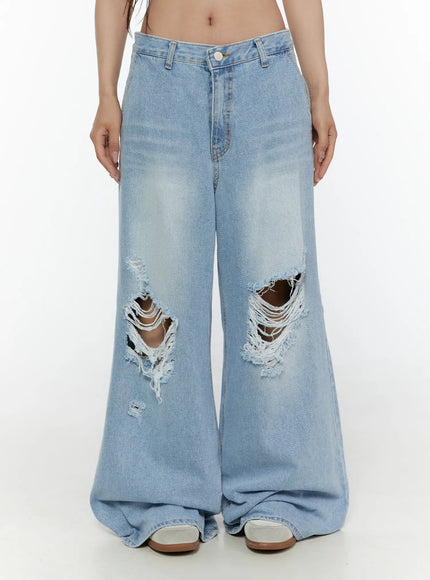 LEWKIN Lou Distressed Wide Leg Jeans CL508 Light blue front crop shot on model wearing white crop top and studded belt