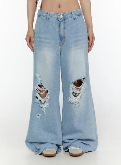LEWKIN Lou Distressed Wide Leg Jeans CL508 Light blue front crop shot on model wearing white crop top and studded belt