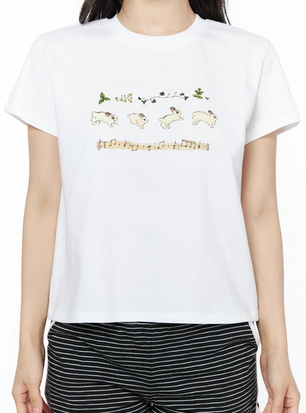 Lovely Bunny Graphic Tee IU525 White close-up front shot on model showing jumping bunny, botanical and music score graphic detail on cotton fabric