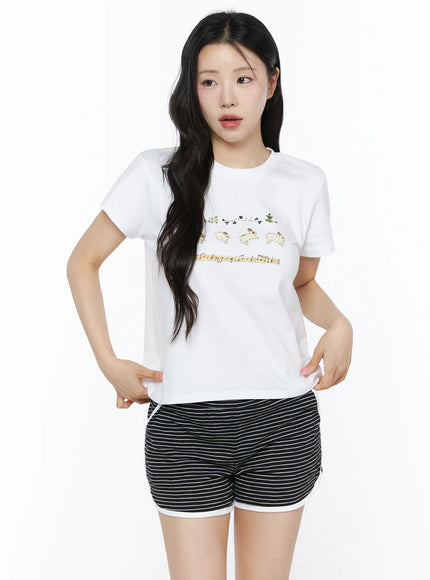 Lovely Bunny Graphic Tee IU525 White front shot on model hands on hips showing cropped silhouette with bunny and music note chest graphic