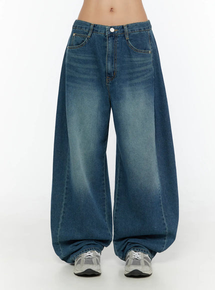 LEWKIN Lovi Washed Wide Leg Jeans CU526 Blue front view on model size S, low-rise waistband with white button, extreme wide-leg washed denim pooling at sneakers