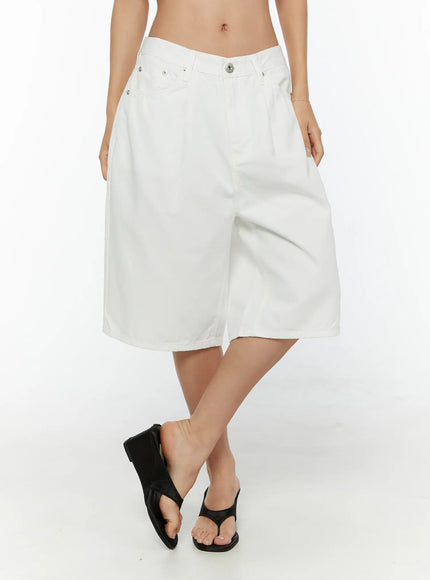 Low-Rise Cotton Shorts CU529 White front close-up on model showing low-rise waistband silver rivets pleated wide leg and black thong sandals