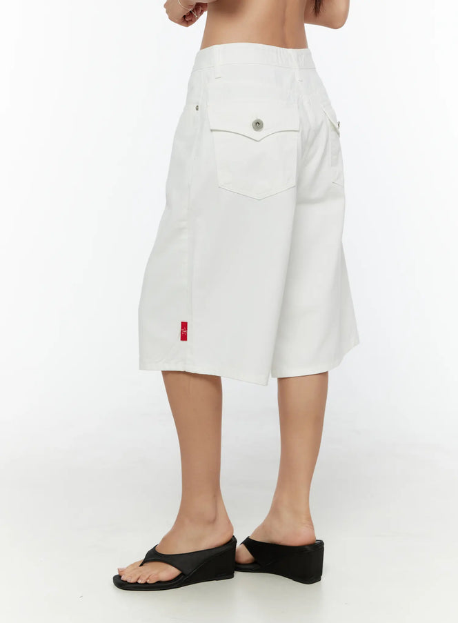 LEWKIN Low-Rise Cotton Shorts CU529 White size 1XS side view on model wearing black wedge sandals showing back pocket with snap button and red TWS label