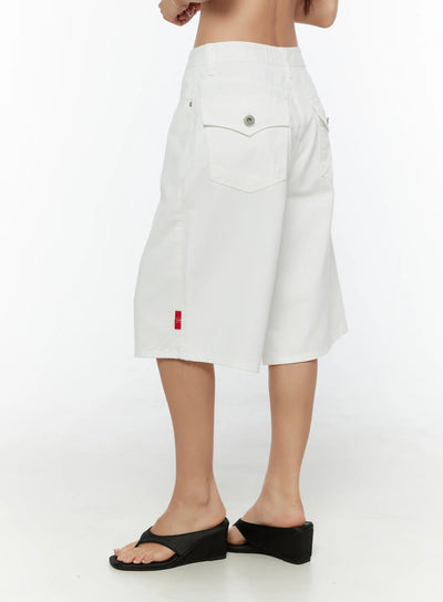 LEWKIN Low-Rise Cotton Shorts CU529 White size 1XS side view on model wearing black wedge sandals showing back pocket with snap button and red TWS label