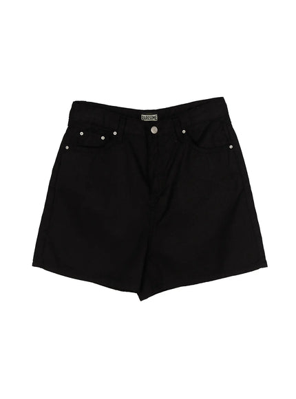 Low-Rise Cotton Shorts IL506 Black flat-lay front detail view showing RARESOME brand label, silver rivets, button fly, and wide cotton twill fabric