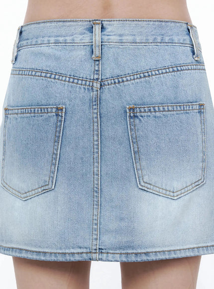 Low-Rise Denim Mini Skirt IL502 Light blue close-up back detail showing dual patch pockets, center seam and light wash denim texture