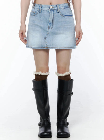 LEWKIN Low-Rise Denim Mini Skirt IL502 Light blue front view on model wearing black knee-high boots with ruffle socks, washed denim texture